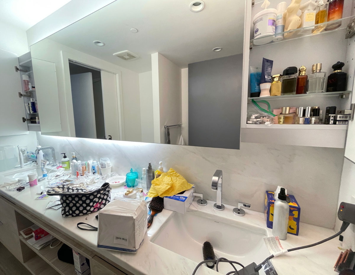 This bathroom is on the messier side. Toiletries and cosmetics are covering the counter, towels and clothes may be left on the floor, and there may be difficult stains in the shower or toilet.