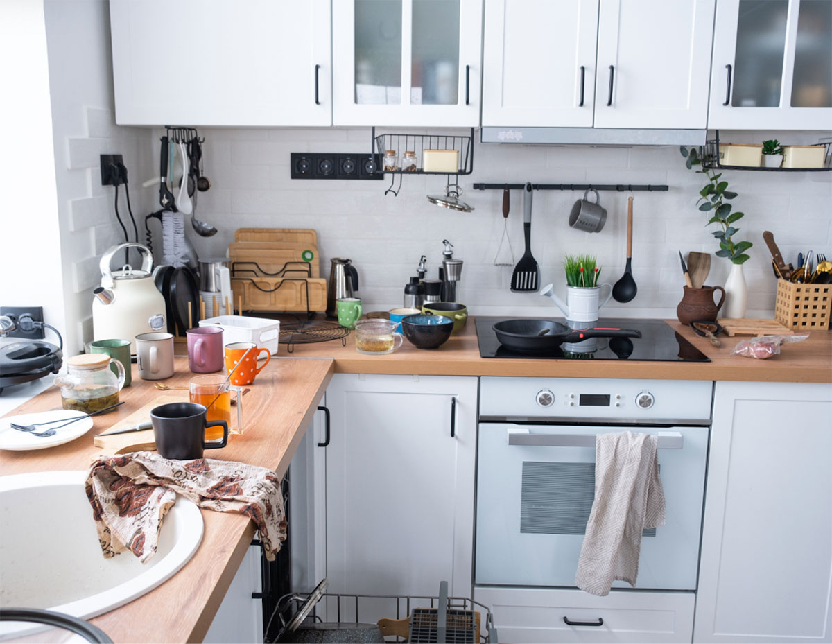 This kitchen belongs to those who cook frequently or tend to have a sink full of dishes. You might also find empty bottles, takeout containers, or other everyday items on the counters.