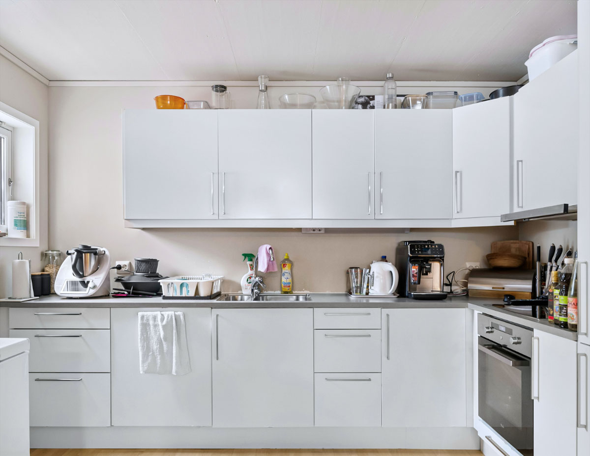 This kitchen likely belongs to someone with limited storage space or who prefers keeping cooking essentials within easy reach. While everything is organized, the countertops are thoughtfully arranged with many items on display.