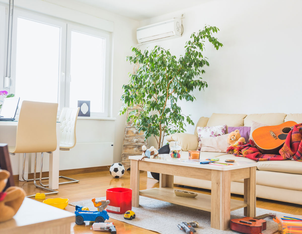 This living room could belong to many different people—whether it's a busy parent managing little ones or a professional who struggles to keep up with tidying. It belongs to  those who don't have time to regularly clean or pick up clutter, toys, clothes, and more.