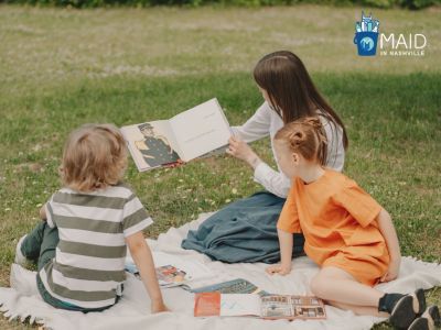 woman reading book with kids at the park is one of the free things to do in Franklin TN