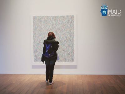 girl is standing in front of art