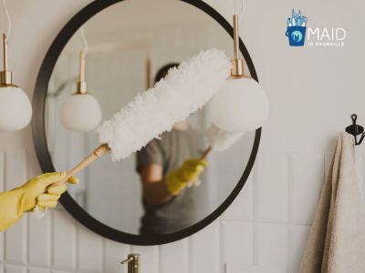 house cleaners in Nashville is dusting the lamp and mirror